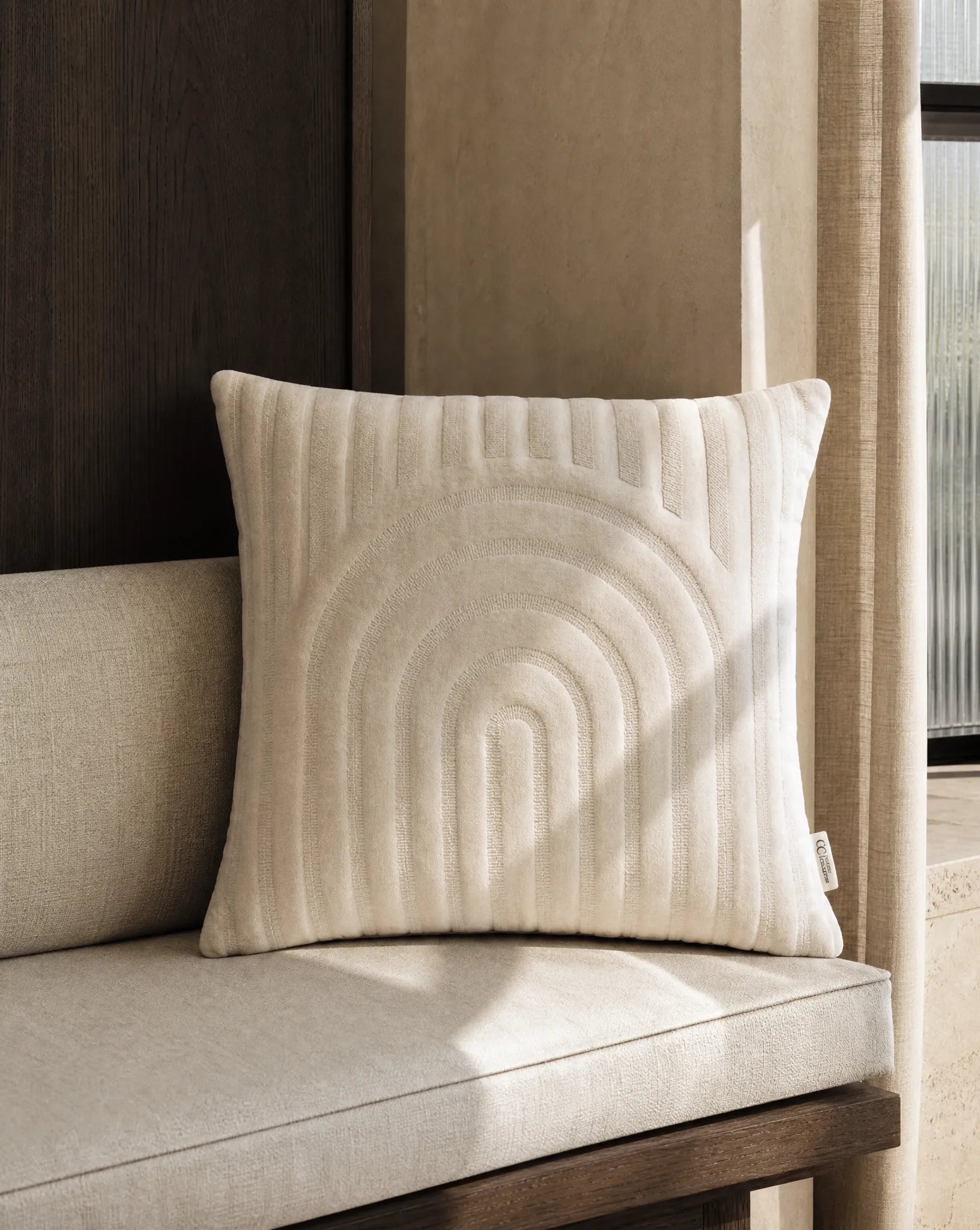 Kuddfodral Arch Birch 50x50 cm från Classic Collection i enfärgad bomullssammet, stylatpå en ljus soffa i en varm, neutral interiör.