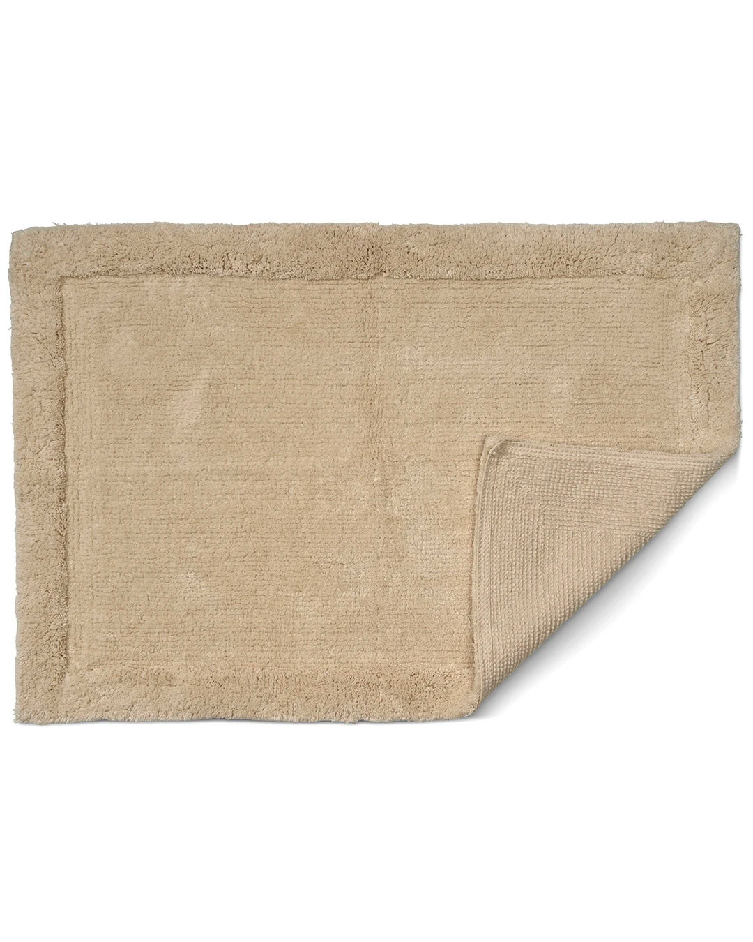 Beige badrumsmatta Border i bomull, 60x90 cm, med uppvikt hörn som visar mattans struktur och baksida.