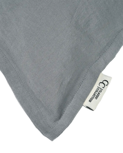 Close-up of a grey linen throw pillow cover with a stitched edge and Classic Collection brand label.