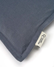 Close-up of a blue canvas cushion with a visible fabric texture and a branded Classic Collection tag.