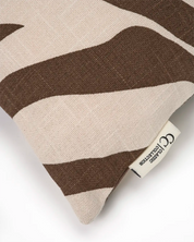 Textured linen throw pillow with brown and beige abstract wavy pattern and Classic Collection logo tag.