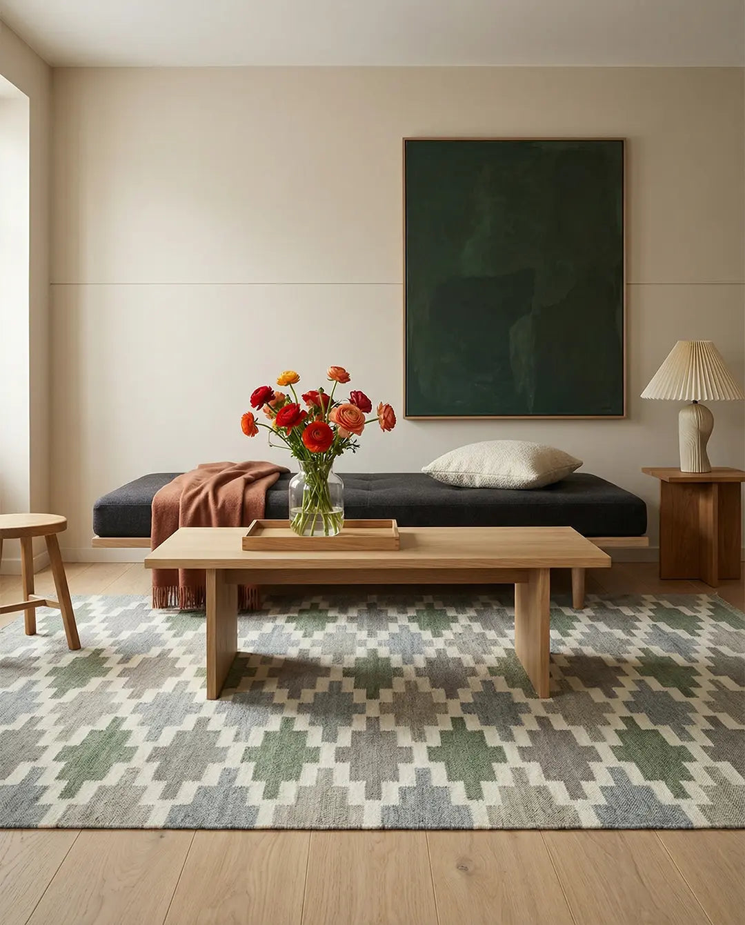 Modern area rug with a geometric green and grey diamond pattern in a minimalist living room with a wooden coffee table.