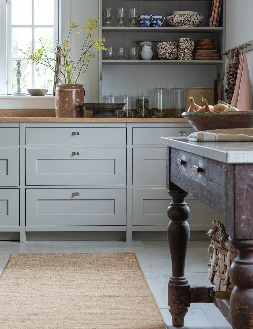 Flatvävd ullgångmatta Plain i naturbeige placerad i kök med köksö, öppna hyllor och trädetaljer