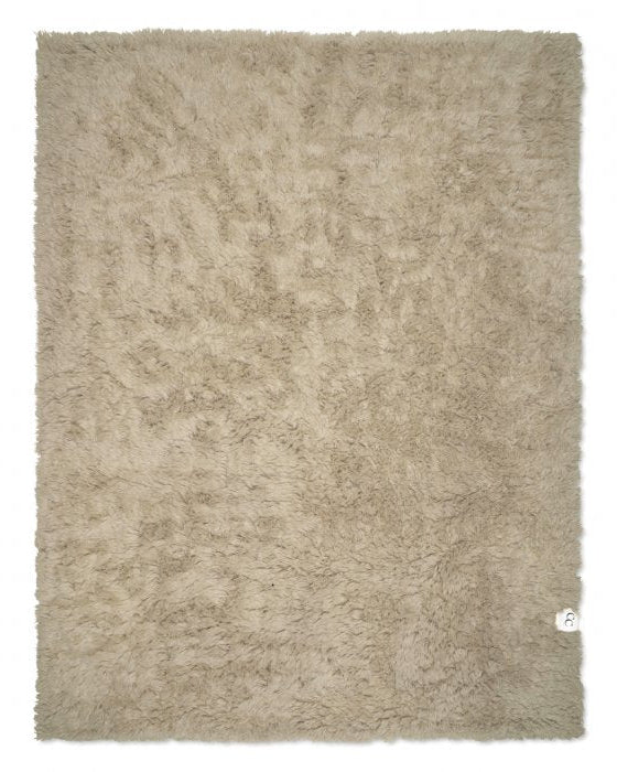 Rectangular beige shag rug with a thick, plush pile and soft textured finish.