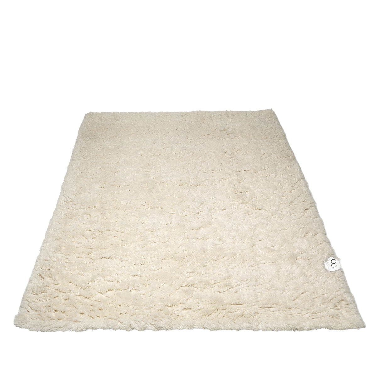 Cream-colored rectangular faux fur area rug with a soft, plush texture.