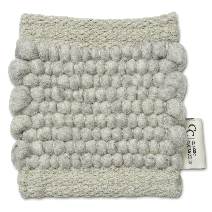 Light grey, hand-woven wool rug swatch with a textured bubble pattern and Classic Collection fabric tag.