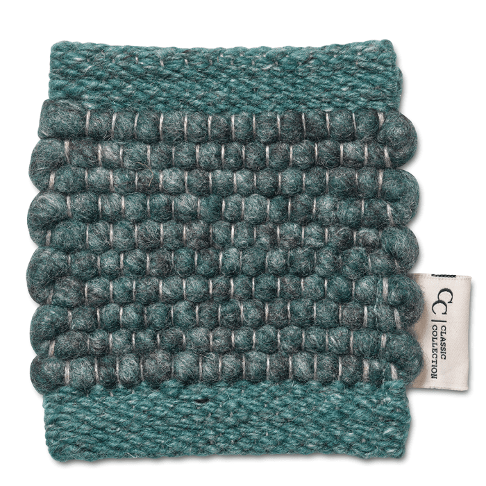 Teal wool carpet swatch with a textured, chunky woven ball pattern and Classic Collection fabric tag.