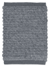 Rectangular grey wool area rug featuring a textured, felted ball pattern with solid woven border edges.