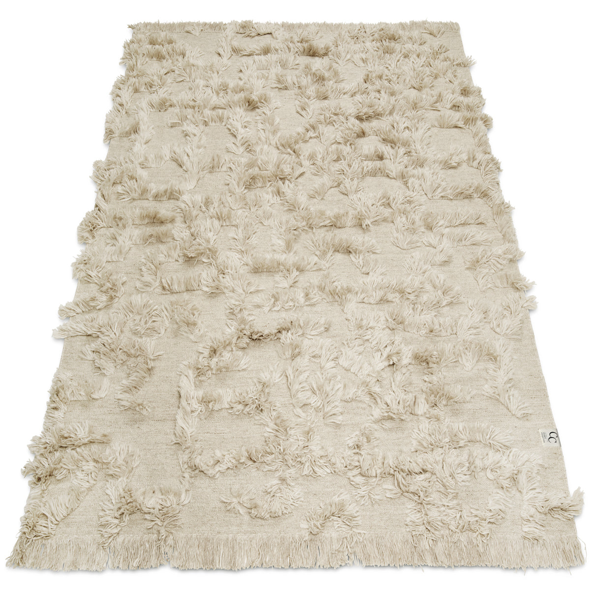 Beige rectangular area rug with a textured tufted pattern, soft fringe edges, and a woven cotton material.