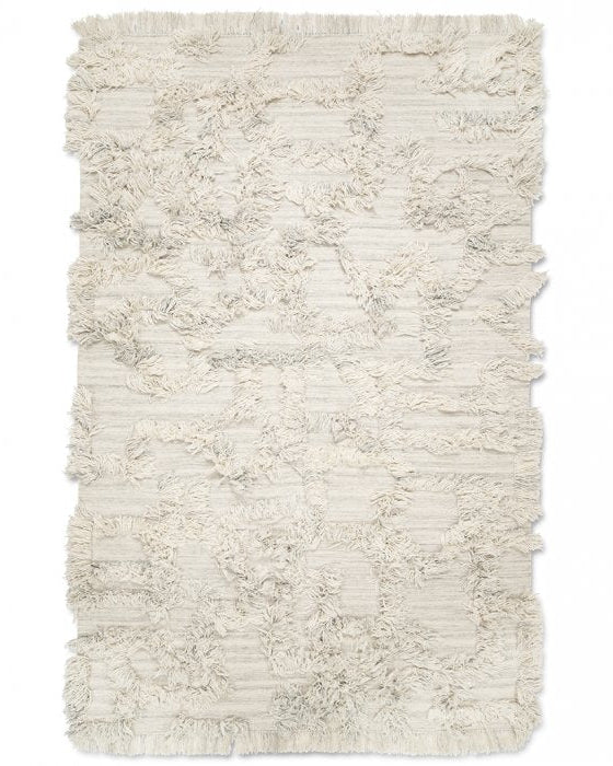 Beige rectangular area rug with textured shaggy Moroccan-style tufted pattern and fringed edges.