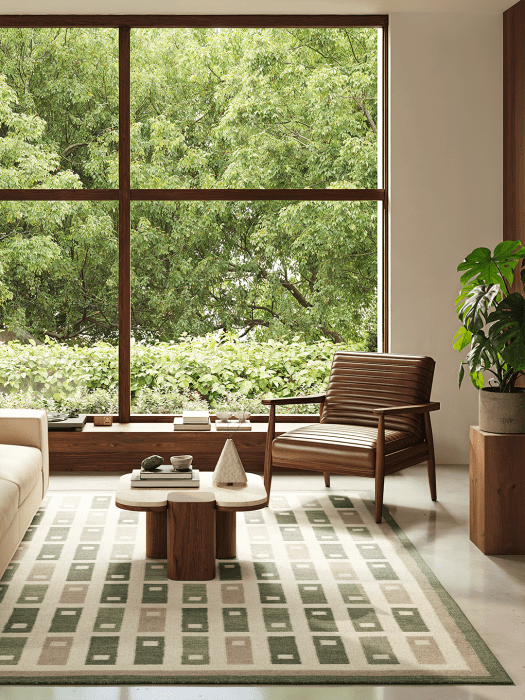 Fyrbo flatwoven wool rug with a geometric pattern in green and beige tones, placed in a bright living room with large windows, s